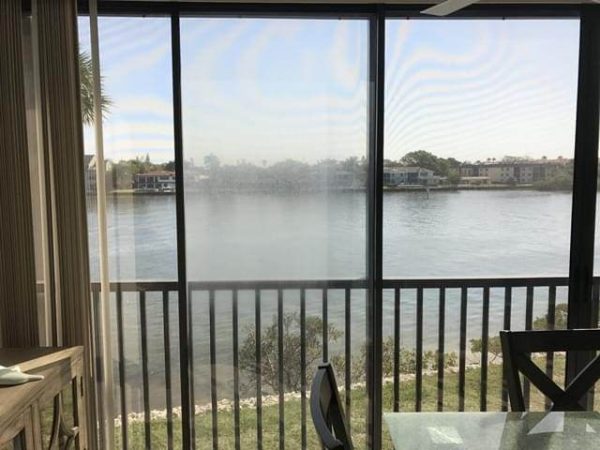 Dining room in condo with window overlooking bay.