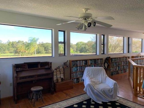 3M™ Sun Control Window Film Night Vision 25 Heat & Glare Reduction Line of windows across living room walls.