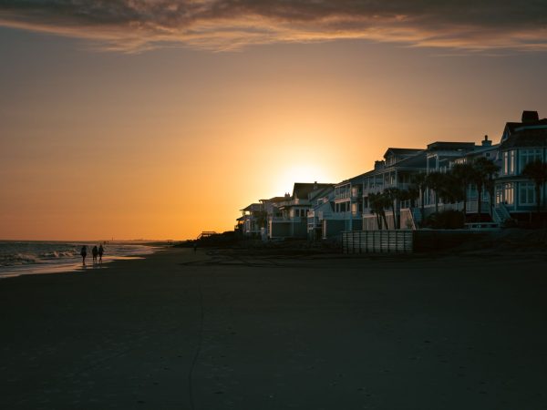 beachfront-homes-lit-windows-at-dusk Beachfront homes at dusk with lit windows facing the sand during nesting season