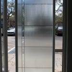 A frosted glass door with 3M decorative film allows light to pass through while obscuring the view of the parking lot and cars outside.