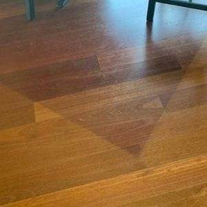 Section of less faded wooden flooring.