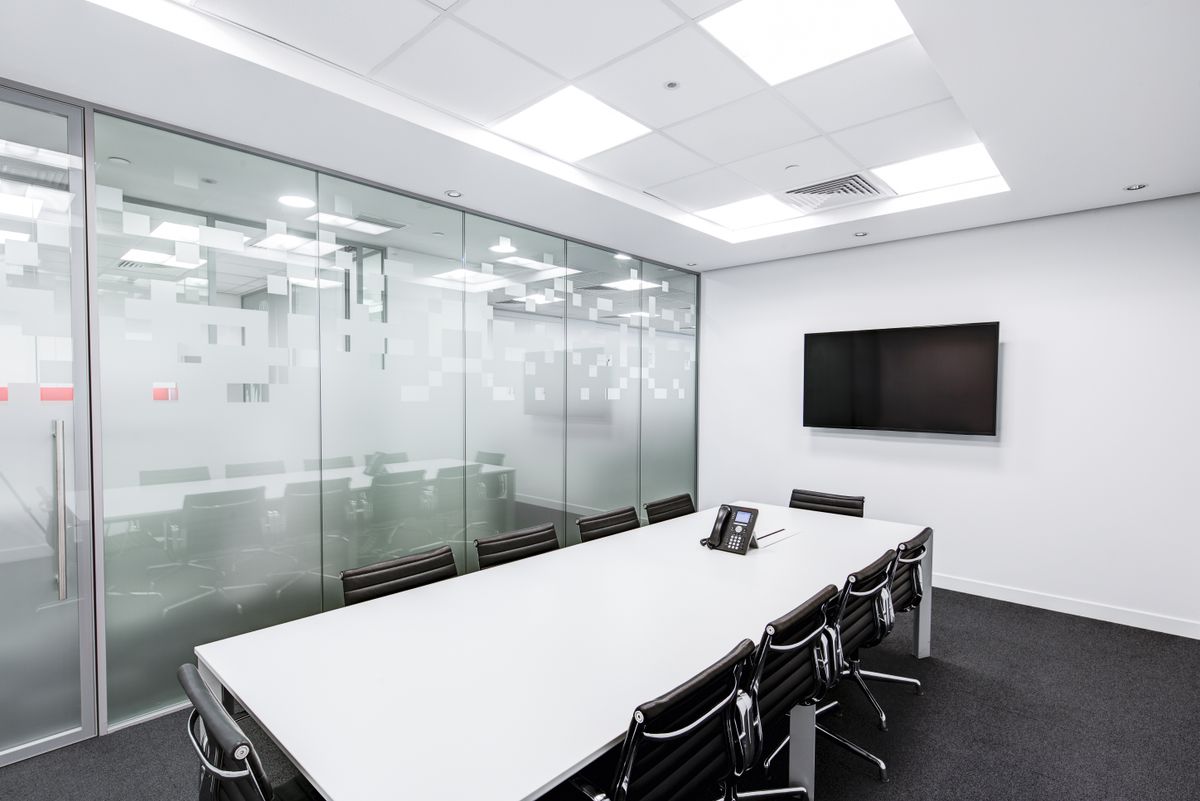 Modern office conference room with frosted glass partition walls
