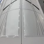 Two white rectangular tables placed side by side, each featuring abstract black and gray curved lines and shapes on their surfaces, enhanced with stylish 3M decorative film.