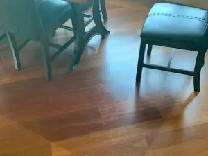 Two chairs on a less faded section of wooden floor.