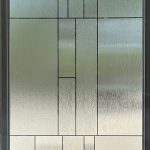 A frosted glass door with a geometric rectangular pattern and a silver frame, enhanced by 3M decorative film; background is faintly visible through the textured glass.