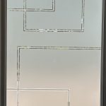 Frosted glass door with a geometric pattern of clear, intersecting squares and rectangles within a dark frame, enhanced by decorative film for added style and privacy.