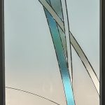 Frosted glass door with abstract geometric design featuring clear and blue textured glass strips, enhanced by decorative film intersecting vertically and diagonally.