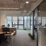 Bright modern office interior with large windows along an open workspace