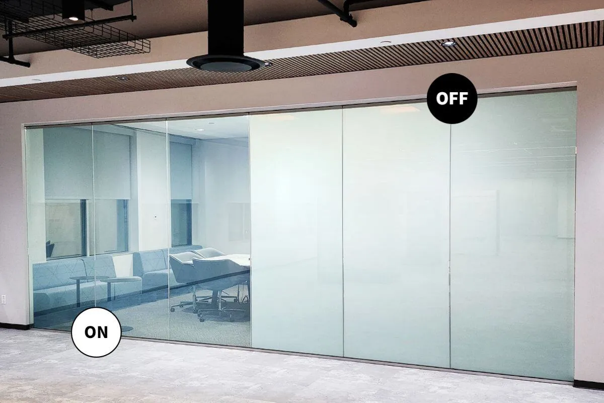 Large glass wall with two sections labeled "ON" and "OFF"; the "ON" section is transparent, showing a meeting room, while the "OFF" section is opaque.