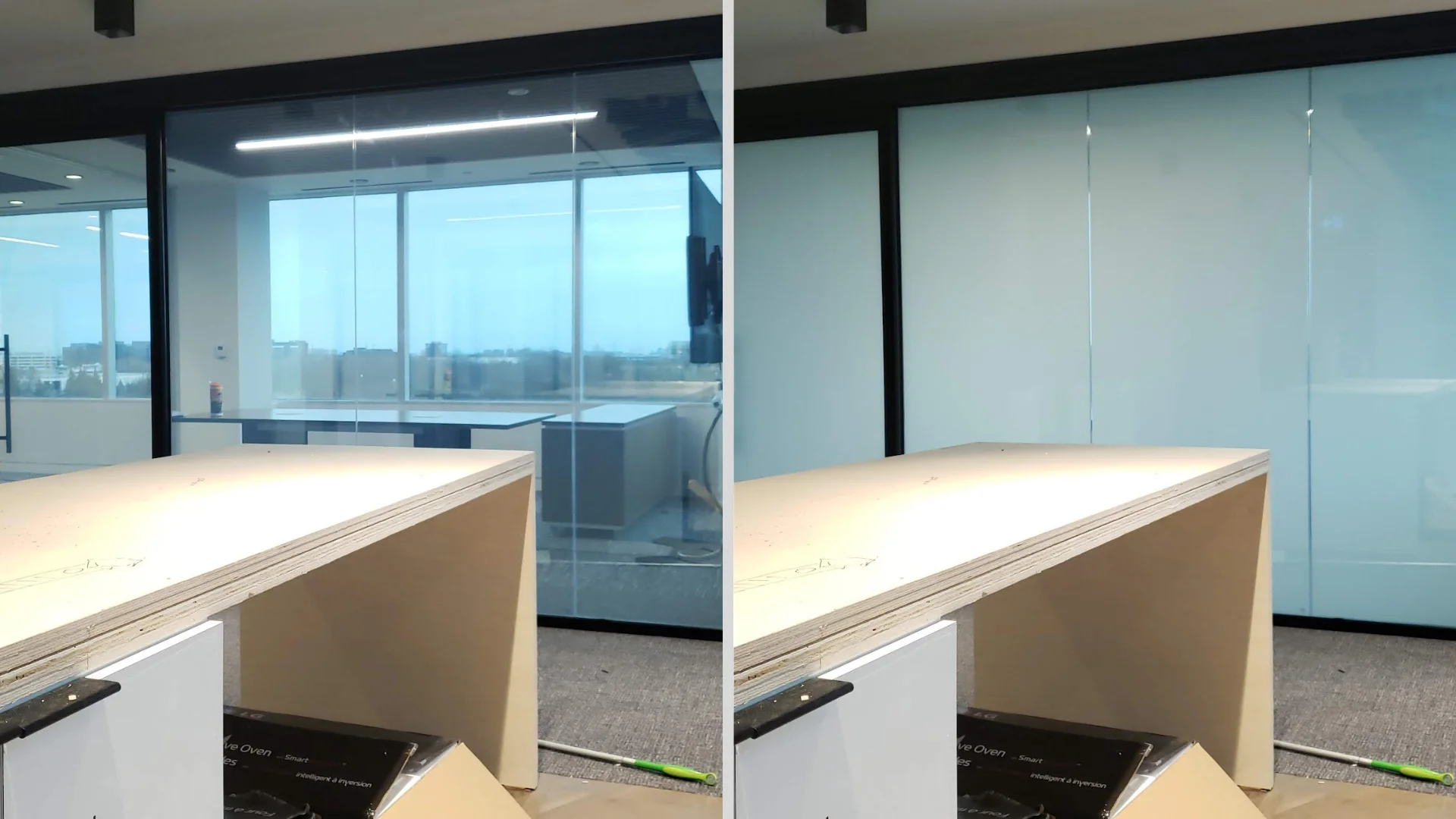 Large glass wall with two sections labeled "ON" and "OFF"; the "ON" section is transparent, showing a meeting room, while the "OFF" section is opaque.