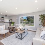 Bright living room with a large window letting in strong Florida sun