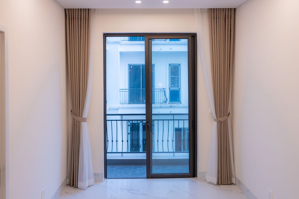 Sliding glass door with solar control film reducing afternoon glare and heat