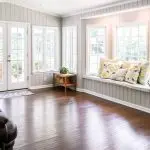 Living room with sun shining across wooden floors