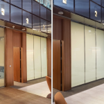 Office glass wall partition before and after frosted privacy film applied beside wood-paneled doors