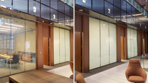 Office glass wall partition before and after frosted privacy film applied beside wood-paneled doors