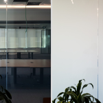 Office glass wall beside plants shown clear then opaque white with smart privacy film